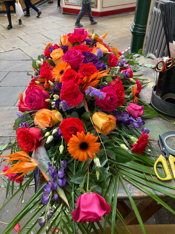 Vibrant colourful casket spray - Alan Brown Flowers